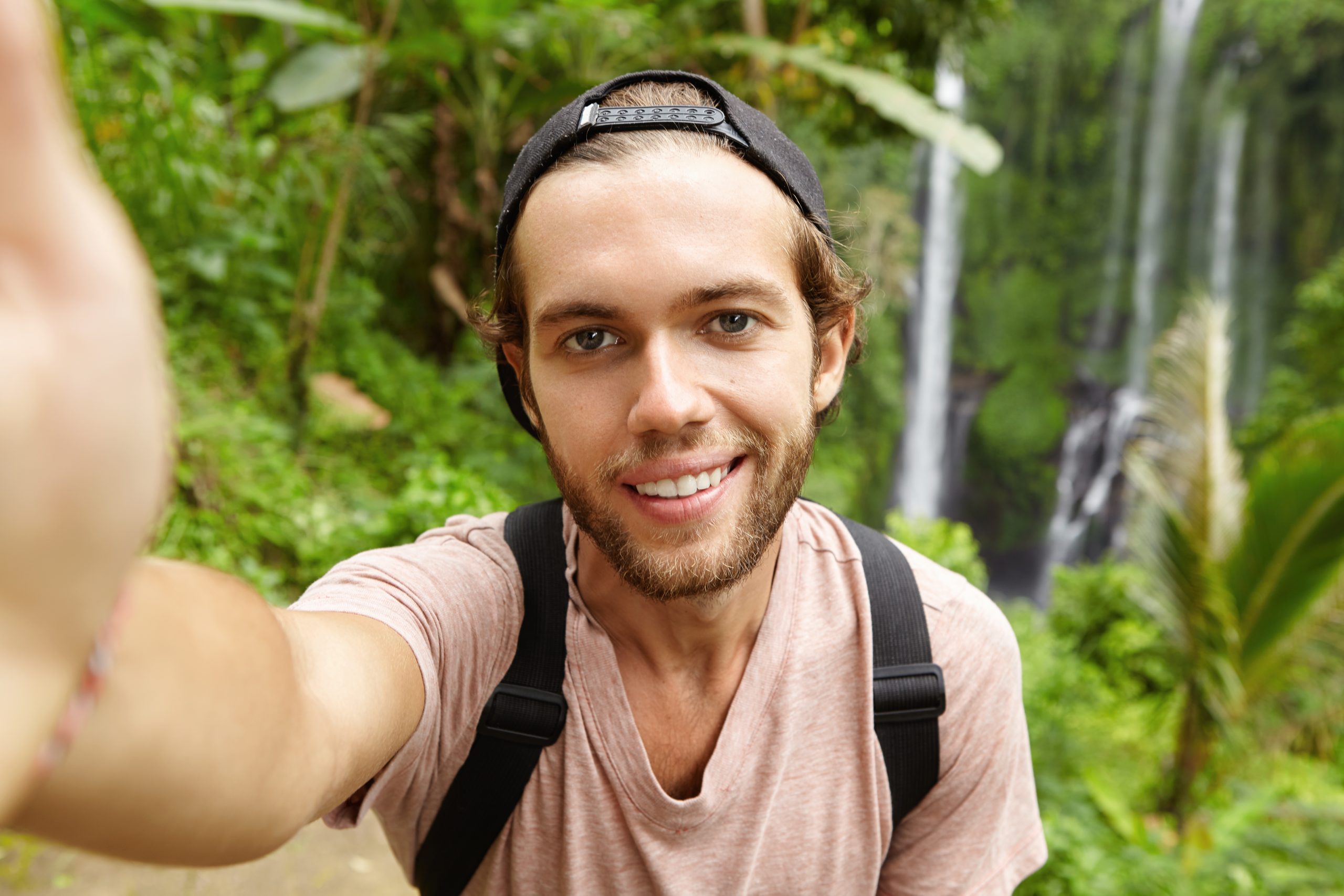 close up view handsome caucasian hiker wearing snapback