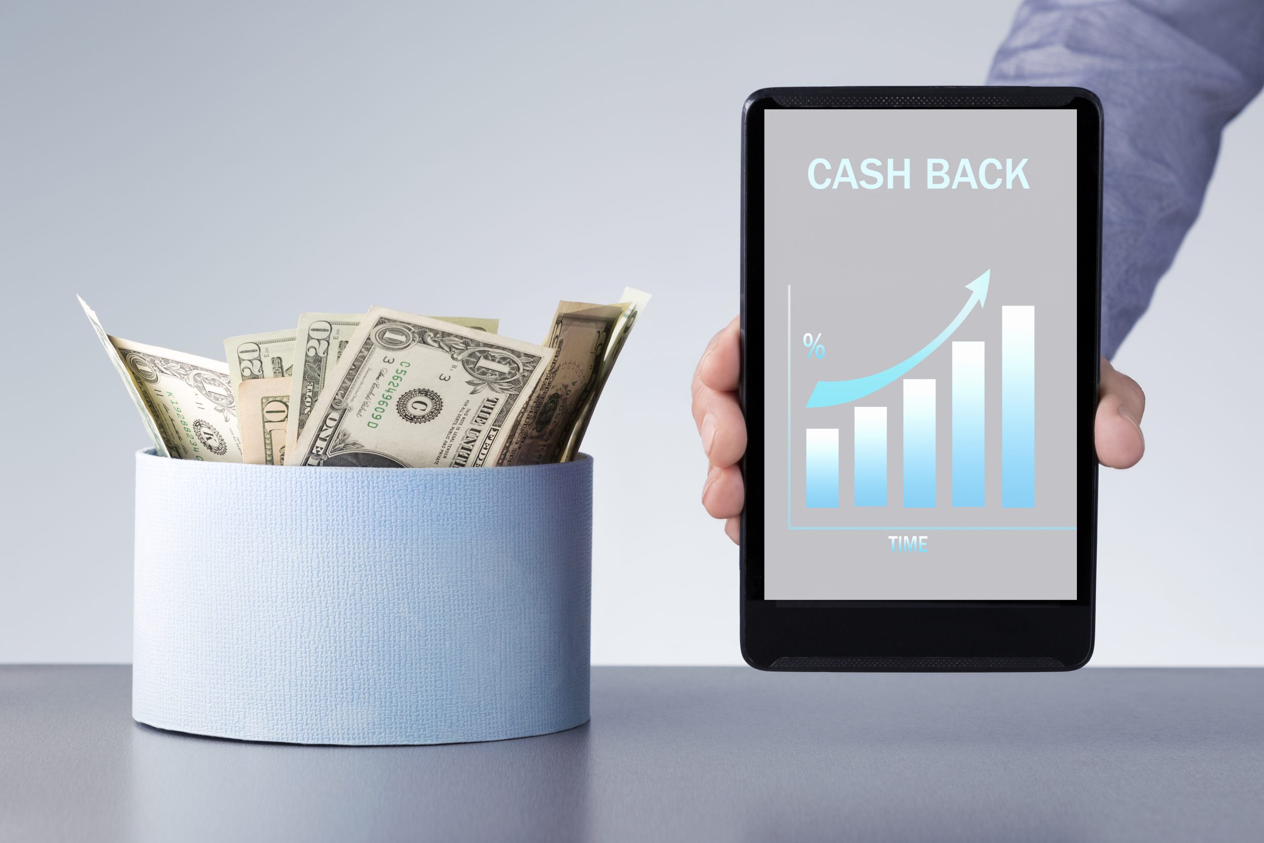 money cashback from internet store man holding digital tablet with growth chart bonus scaled