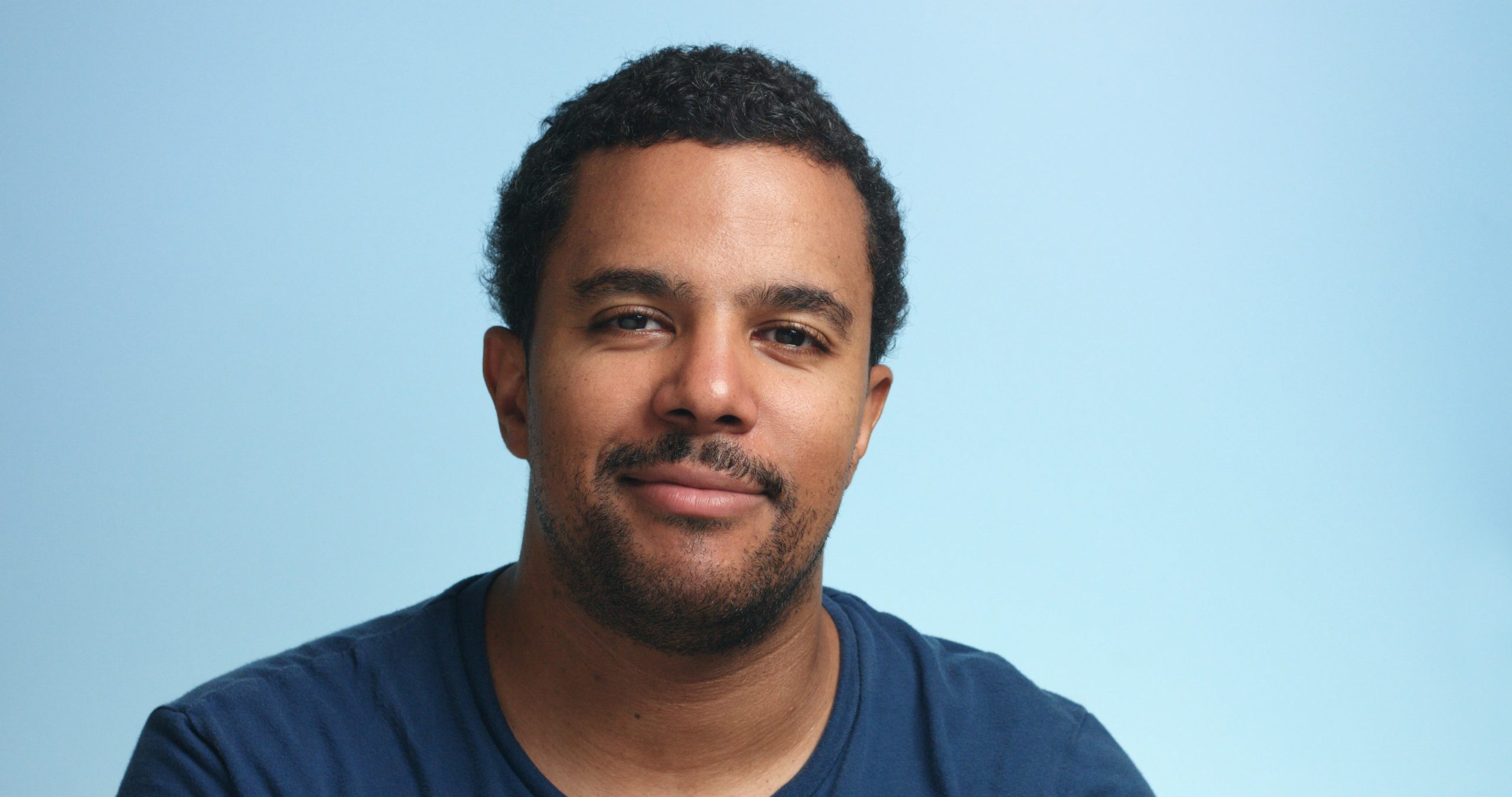sleepy mixed race man portrait deep blue
